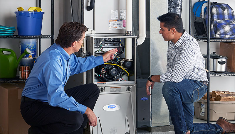 HVAC technician evaluating a furnace for repair or replacement in Tucson
