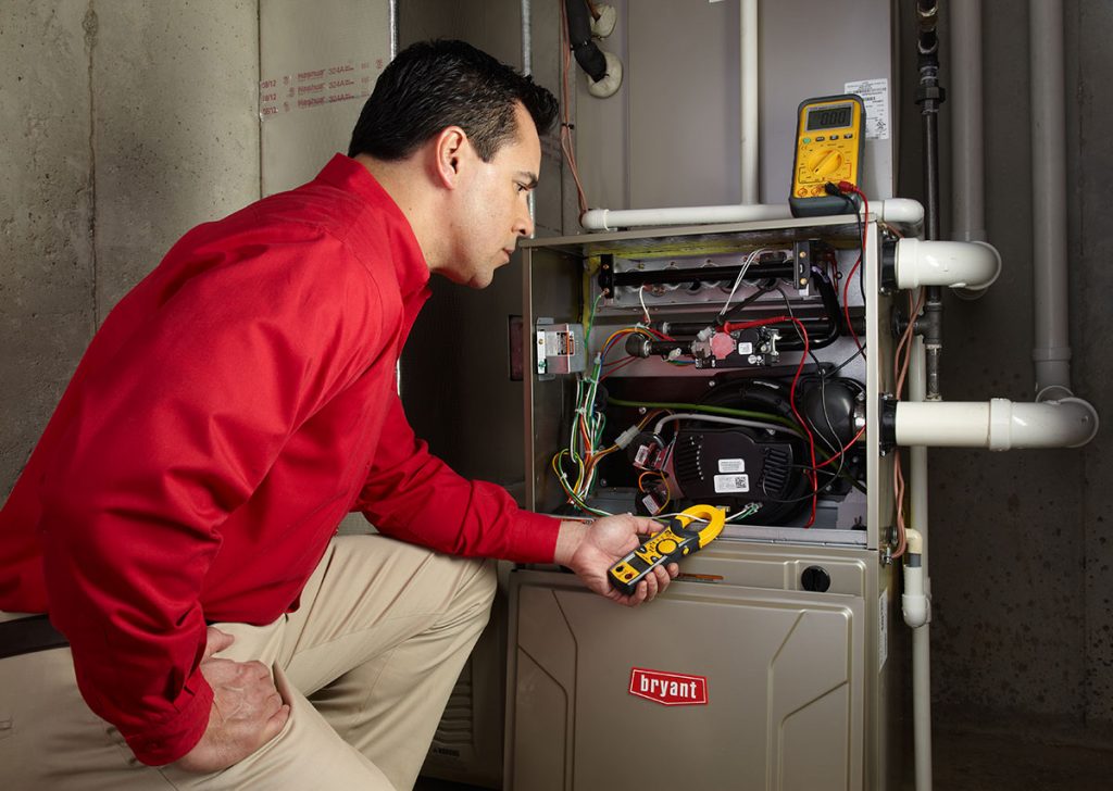 HVAC technician repairing an indoor furnace in Tucson