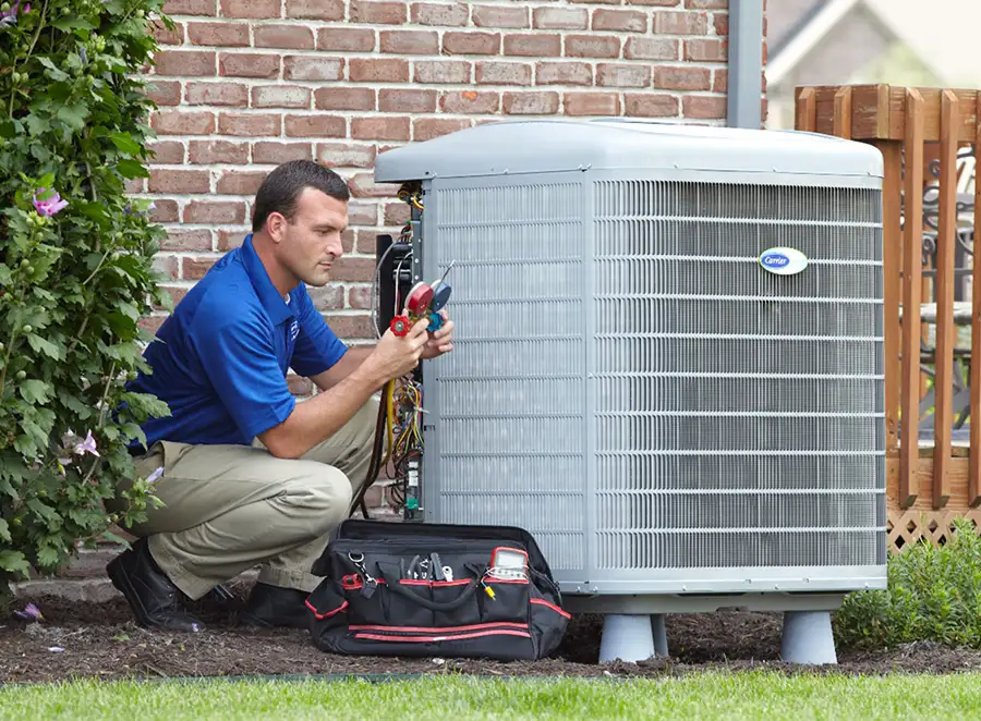 HVAC technician inspecting an outdoor air conditioning unit in Tucson