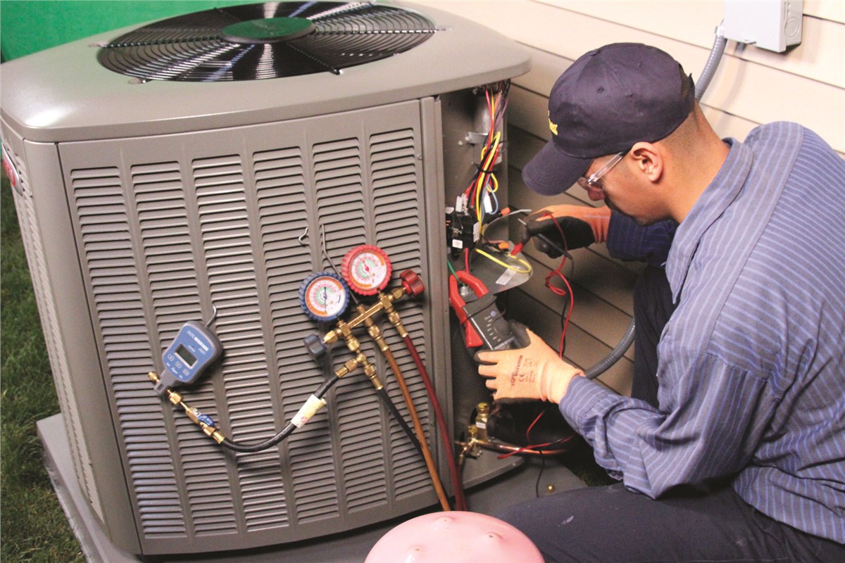 HVAC technician testing an outdoor air conditioning unit in Tucson
